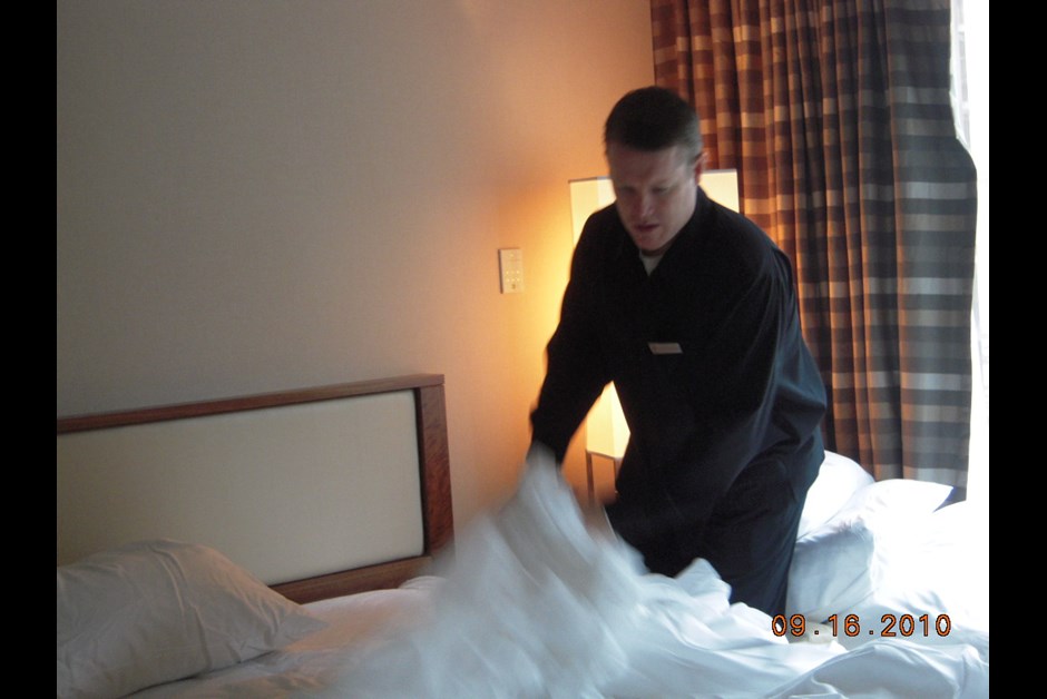Andrew den Oudsten trying his hands at bed making