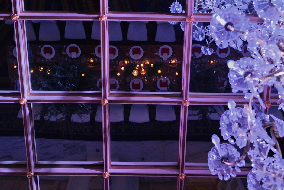 Guests dined beneath a glittering chandelier and mirrored, gilded ceiling