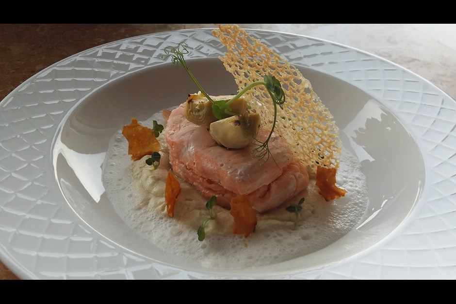 Salmon medallion with truffle on a artichokes velouté with foamed parmesan milk