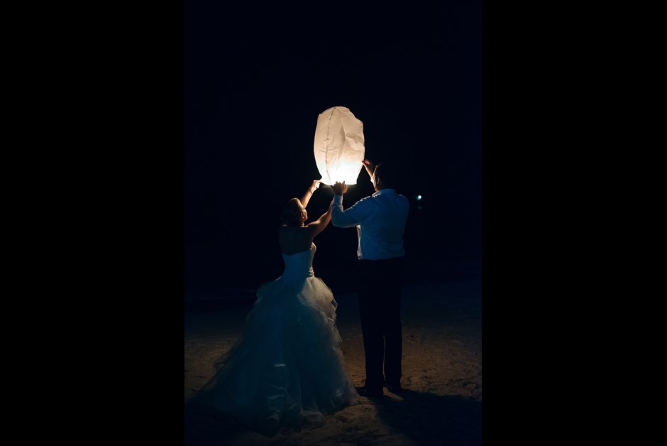 Bride and Groom light lantern on Fairmont Beach 
